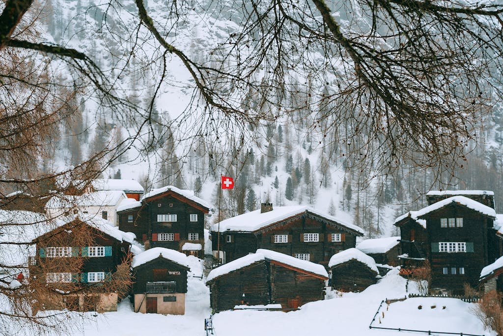 Snowy village houses on hilly terrain
