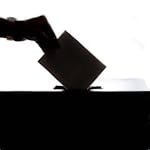 Person Dropping Paper On Box