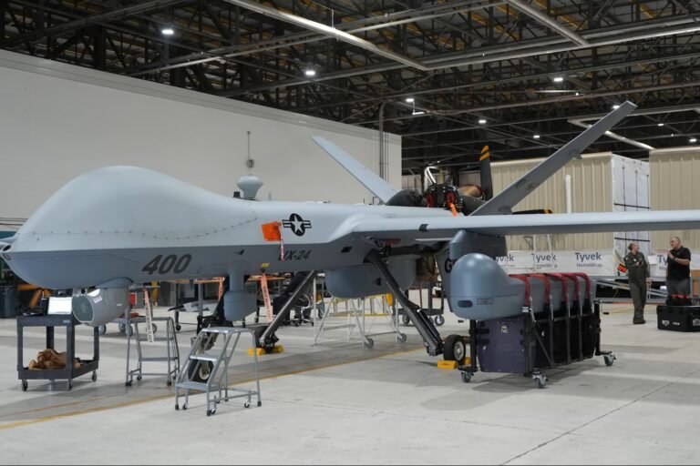 MQ-9 Reaper remotely piloted aircraft carrying Hellfire missiles in flight.