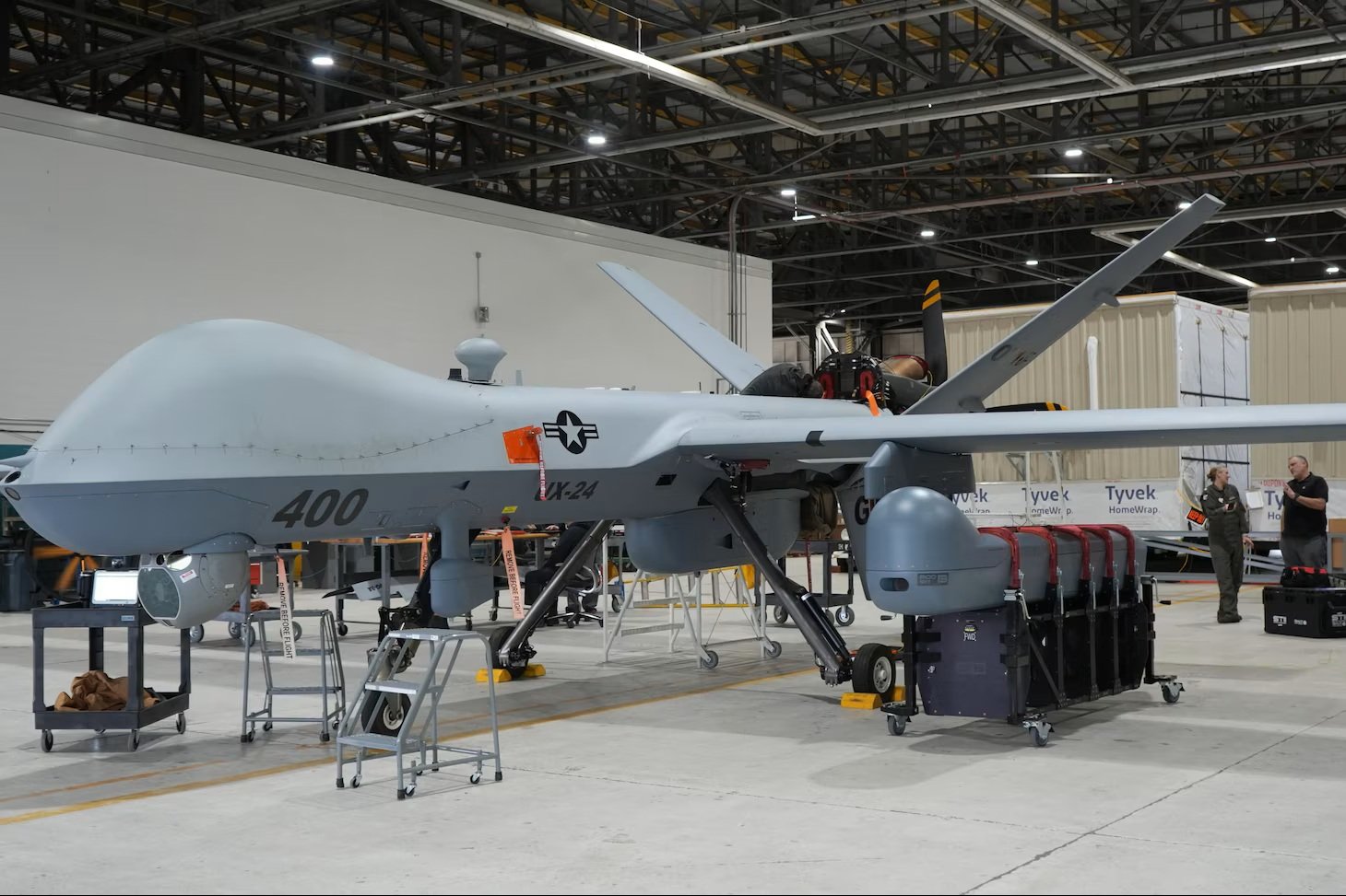 MQ-9 Reaper remotely piloted aircraft carrying Hellfire missiles in flight.